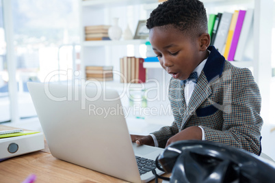 Businessman using laptop at desk