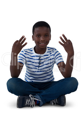 Portrait of boy performing meditation