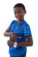 Smiling boy showing his smart watch