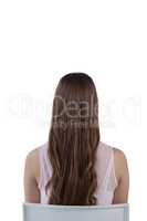 Teenage girl sitting against white background