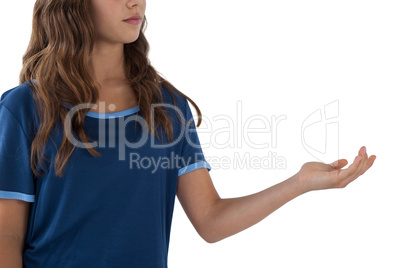 Smiling girl with hand cupped against white background