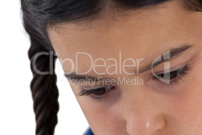 Sad girl looking down against white background