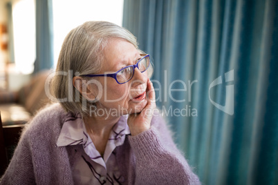 Thoughtful senior woman looking away