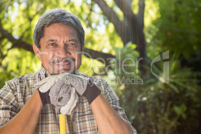 Senior man standing in garden on a sunny day