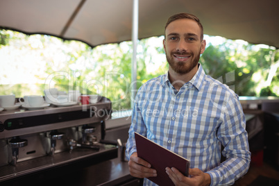 Smiling manager holding clipboard