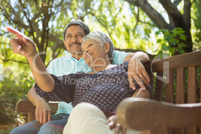 Senior couple pointing to a distance