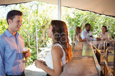 Couple having a glass of beer at counter