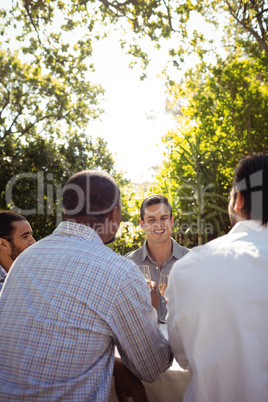 Group of friends interacting with each other while having champagne