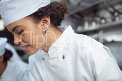 Close-up of female chef in kitchen