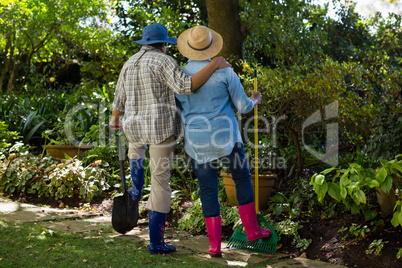 Senior couple standing in garden on a sunny day