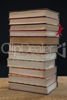 Stacked books on wooden table