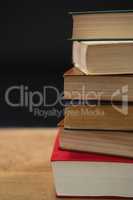 Stack of books on wooden table