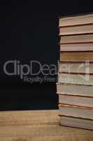 Stacked books on wooden table