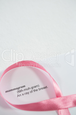 High angle view of pink Breast Cancer Awareness ribbon on paper with text