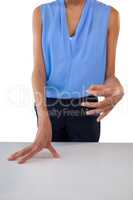 Businesswoman holding something while gesturing at table