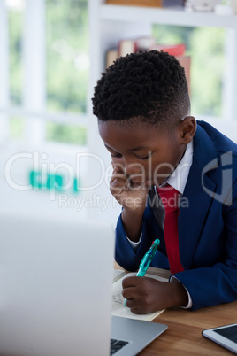 High angle view of businessman writing on paper