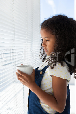 Side view of thoughtful businesswoman holding coffee cup