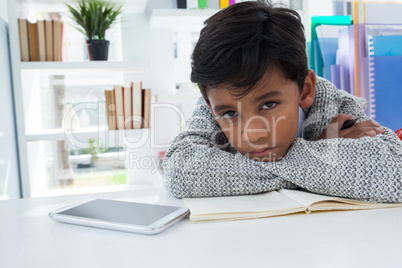 Portrait of businessman leaning on desk