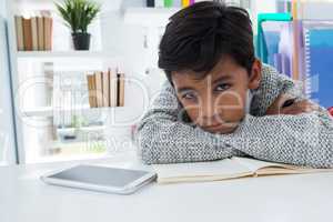 Portrait of businessman leaning on desk