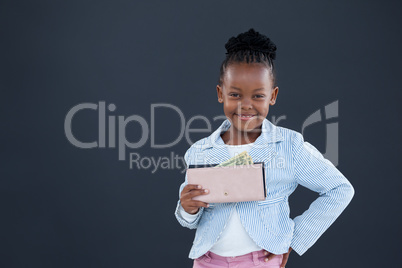 Portrait of smiling businesswoman holding currency purse