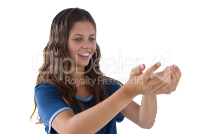 Smiling girl with hand cupped against white background