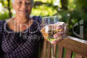 Senior woman holding wine glass