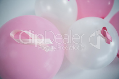 High angle view of pink Breast Cancer Awareness ribbons on balloons