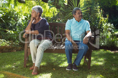 Senior couple arguing while sitting on the bench