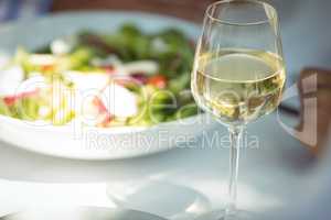 Close-up of food and wine glass on dining table