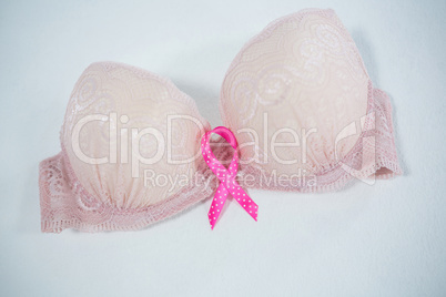 High angle view of spotted pink Breast Cancer ribbon on bra