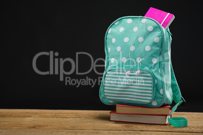 Schoolbag on book stack