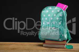 Schoolbag on book stack