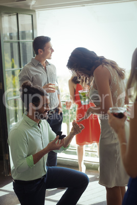 Man proposing woman with engagement ring