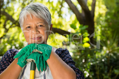 Senior woman standing in garden on a sunny day