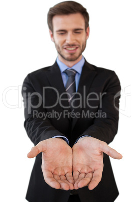 Smiling businessman in suit standing with hands cupped