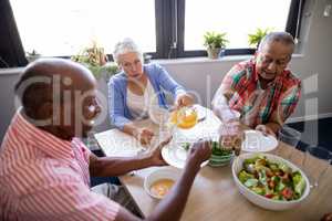 High angle view of senior people having salad and juice
