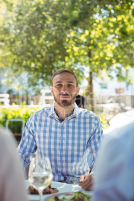 Man having breakfast at outdoor restaurant