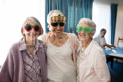 Smiling senior women wearing novelty glasses