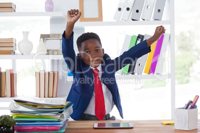 Smiling businessman stretching while sitting