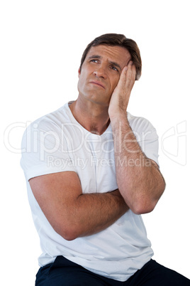 Thoughtful mature man sitting with head in hands