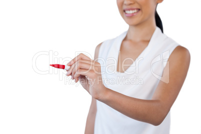 Mid section of smiling businesswoman writing on invisible glass