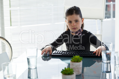 Portrait of creative businesswoman sitting at desk