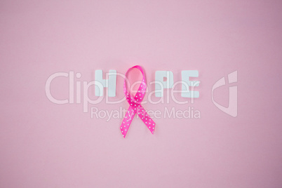 Overhead view of spotted Breast Cancer Awareness ribbon with HOPE text
