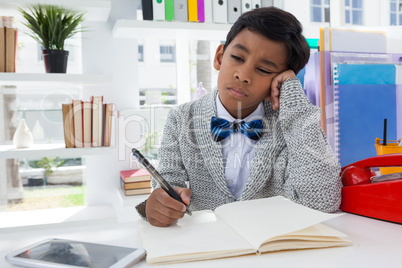 Bored businessman holding pen