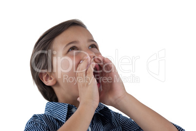 Cute boy shouting against white background