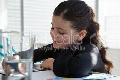 Close up of smiling businesswoman reading document at desk
