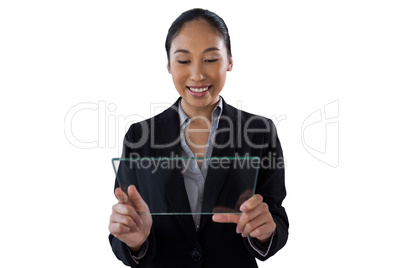 Happy young businesswoman holding glass interface