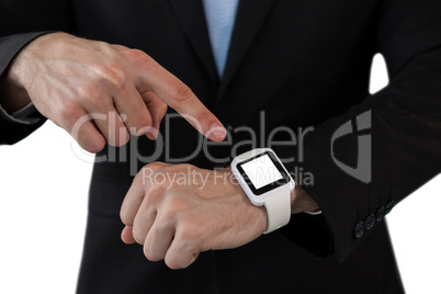 Mid section of businessman pointing on smart watch