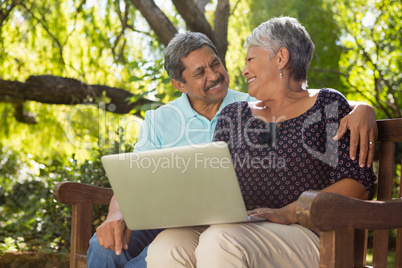 Senior couple using laptop