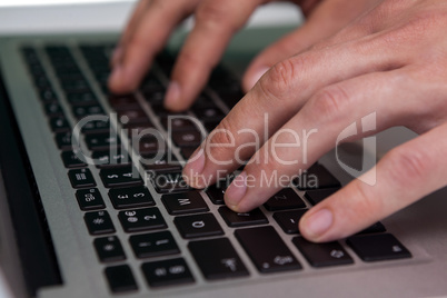 Close up of businessman typing on laptop computer